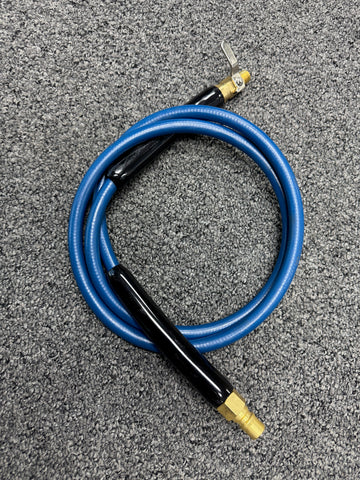 Blue hose with black nozzle on a gray surface